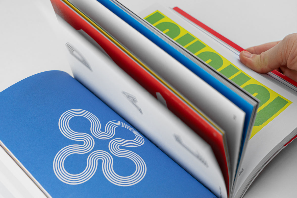 Félix Beltrán: Visual Intelligence – the book open at an angle, a logo on a blue page